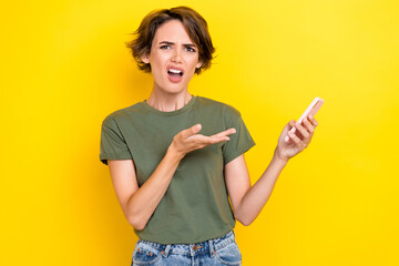 Photo of upset unsatisfied woman bob hairdo dressed khaki t-shirt palm directing at smartphone...