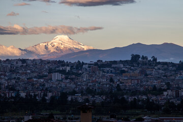 View of the beautiful Cayambe Volcano from the city of Quito on a summer day.