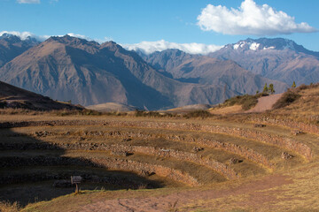 View of the mountains and terraces inside the Moray Ruins during sunset, Sacred Valley, Peru.