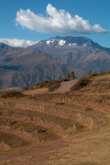 Naklejka premium View of the mountains and terraces inside the Moray Ruins during sunset, Sacred Valley, Peru.