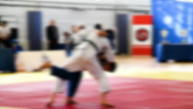 Judo competitions. Young athletes compete on the tatami. Judo. Blurred.