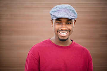 Close up portrait of handsome young black man with cap