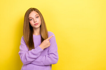 Photo of pretty serious lady calm face wear stylish violet cozy autumn sweater arm direct empty space isolated on yellow color background