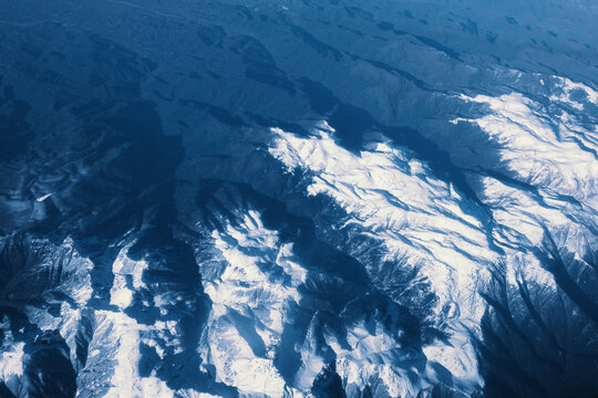 Ice-covered mountain peaks. View from above