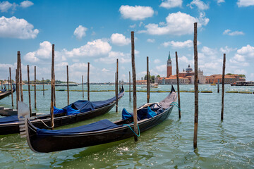 Fototapeta na wymiar Close-up of a gondola and a series of Venetian gondolas with no one on board.
