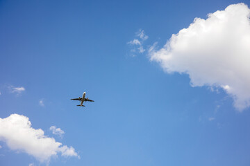 Beautiful Panoramic Background with flying plane in blue sky. Passenger airplane with landing gear released takes off in sky. Travel concept. Wide Angle Wallpaper or Web banner With Copy Space