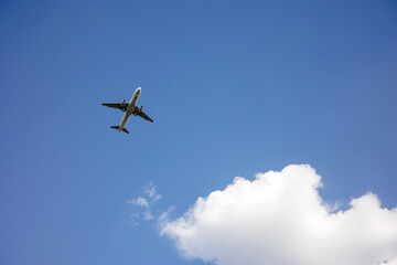 Beautiful Panoramic Background with flying plane in blue sky. Passenger airplane with landing gear released takes off in sky. Travel concept. Wide Angle Wallpaper or Web banner With Copy Space