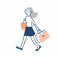 ショッピングバッグを持って歩く若い女性