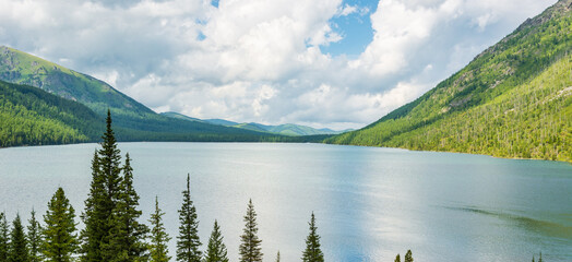 Mountain landscape with beautiful view of the lake and coniferous tree tops