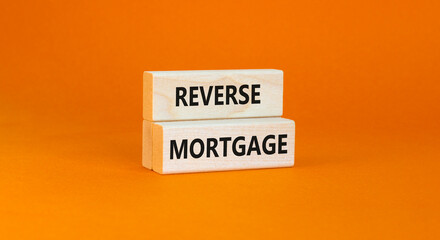 Reverse mortgage symbol. Concept words Reverse mortgage on wooden blocks. Beautiful orange table orange background. Business and reverse mortgage concept. Copy space.