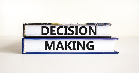 Decision making symbol. Concept words Decision making on books. Beautiful white table white background. Business and decision making concept. Copy space.