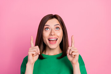 Closeup photo of young gorgeous lady directing fingers looking up good news nice smile isolated on pink color background