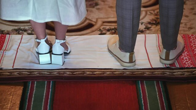 The newlyweds stand on a rushkin during the wedding ceremony. East Slavic tradition.