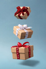 Flying Christmas gift boxes on blue background.