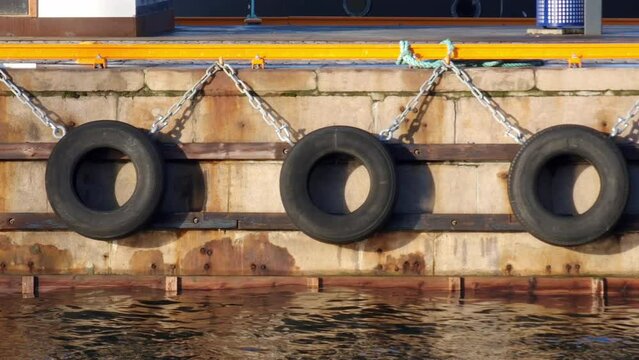 Old tires as marine fenders, used at harbors, ports, marinas and docks on quay walls, jetties and other berthing structures, preventing damage to the vessel (yacht, boat or ship). 
