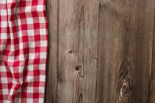 Wooden table with red checkered tablecloth