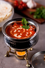 Chicken Tikka Masala or butter chicken makhani served in handi isolated on table side view of...