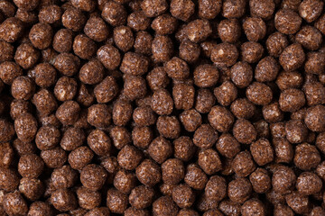Chocolate breakfast cereal texture. Cereal balls as background.