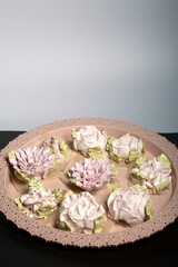 Obraz na płótnie Canvas Marshmallow flowers on a tray. Marshmallow flower buds. Homemade sweets.