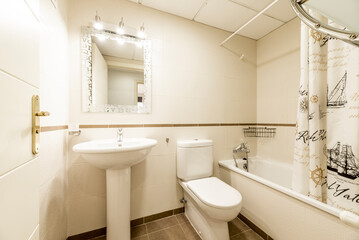 Bathroom with white porcelain toilets, mirror with light fixtures and white wooden door