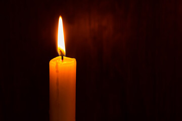 lighting a candle with a match in the dark. Copy space