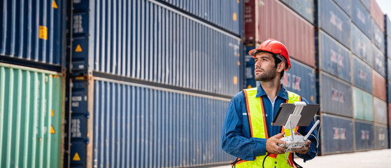 A foreman or worker pilots a drone at a container port used a remote controller for checking container.