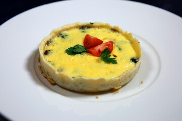 Kish loren with mushrooms, tomatoes and cheese. Baked Lauren quiche with bacon. Pie with cheese filling and tomatoes. Open Shortbread Pie Quiche Loren. The concept of French cuisine.