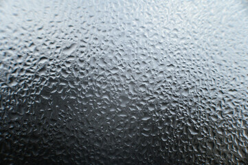 Texture on the window made of condensation and water drops.