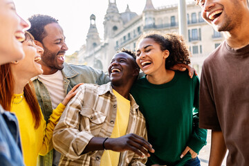 Young group of happy people having fun outdoors. Millennial diverse friends laughing enjoying...