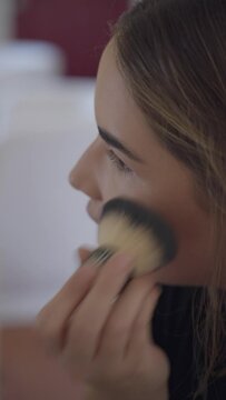 Following a young woman as she gets ready and puts on makeup.
