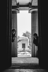 Dark gothic couple in large ancient abandoned mausoleum in Roman Pantheon style (in black and white)