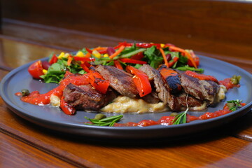 beef chop steak with salad , fried potatoes and  sauce in dish. Food and Vegetable concept. Restaurant and menu theme. With Red Wine.