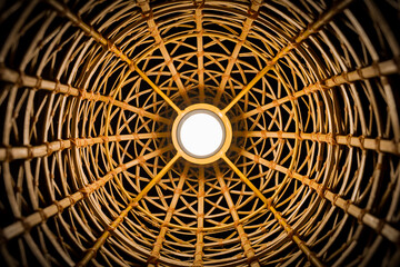 Perspective Photography of wicker texture with a handmade traditional light bulb, abstract background. The ancient classic pattern of bamboo Thai wickerwork.
