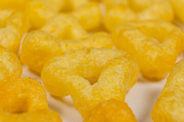 Delicious crispy corn chips triangular shape with spices, macro.