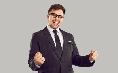 Happy funny excited man celebrating business success. Cheerful overjoyed euphoric man in suit and...