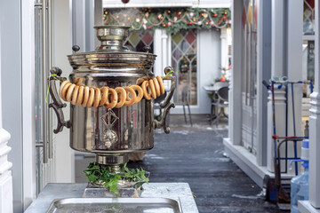 Traditional Russian samovar with bagels in a street cafe.