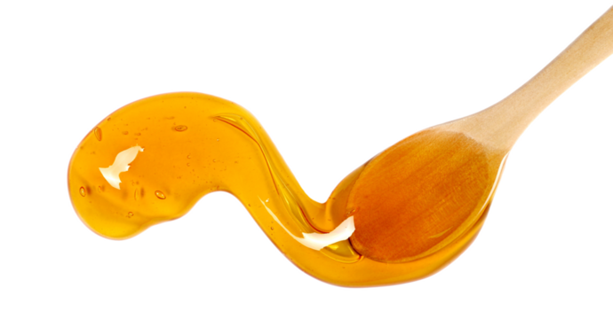 Honey puddle with wooden spoon isolated on white, top view