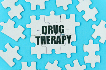 On a blue background are white puzzles with the inscription - Drug Therapy