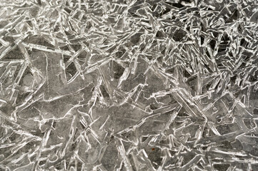 Frosty pattern on the river. Cracked ice in winter. Frozen river in winter. Frozen water.