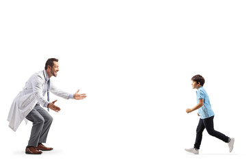 Boy running towards a male doctor