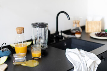 kitchen with dirty countertop, glasses and utensils