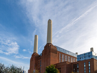 Chimneys and brick facade of iconic London landmark Battersea Power Station and surrounding area.