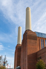 Chimneys and brick facade of iconic London landmark Battersea Power Station and surrounding area.