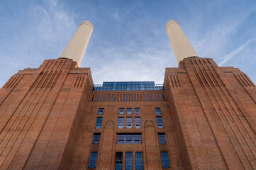 Low angle view at chimneys and brick facade of iconic London landmark Battersea Power Station and...