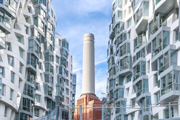One of four chimneys of iconic London landmark Battersea Power Station and surrounding area with appartments and offices.