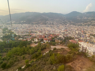 A beautiful tourist city with modern buildings on a mountain with trees, a view from the top of the...