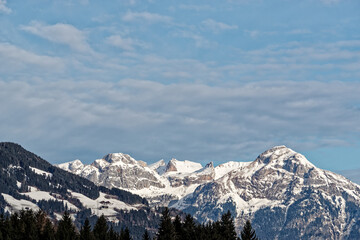 Fototapeta na wymiar Snow-capped mountains against blue sky