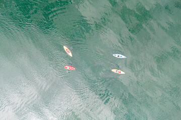 Aerial top down view of sport canoes rowing on the Broken Bow lake, Oklahoma, USA. Kayaking on...