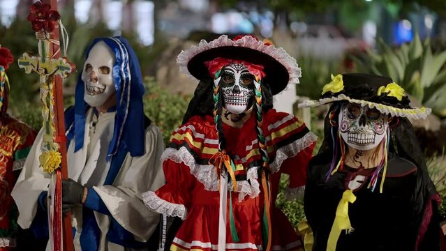 Group of girls with carnival masks for the day of the death, dia de los muertos 