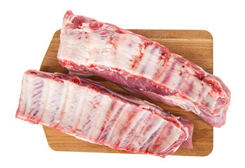 Pork ribs on a wooden board isolated on a white background.